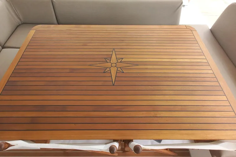 Amea Yacht Photos Pics Wooden table with compass rose design on Lagoon 52 F yacht, 2014 model.