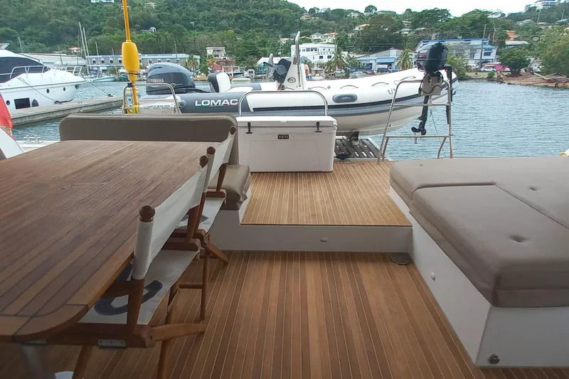 Amea Yacht Photos Pics Luxurious 2014 Lagoon 52 F yacht deck with seating and dining area, docked at marina.