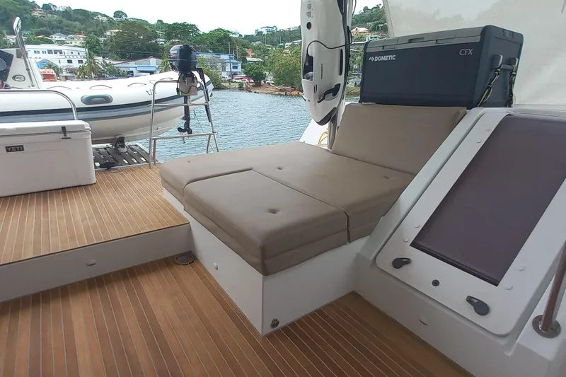 Amea Yacht Photos Pics Luxurious 2014 Lagoon 52 F yacht deck with seating and scenic waterfront view.