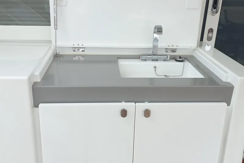 Amea Yacht Photos Pics 2014 Lagoon 52 F yacht sink with modern faucet and storage cabinets.