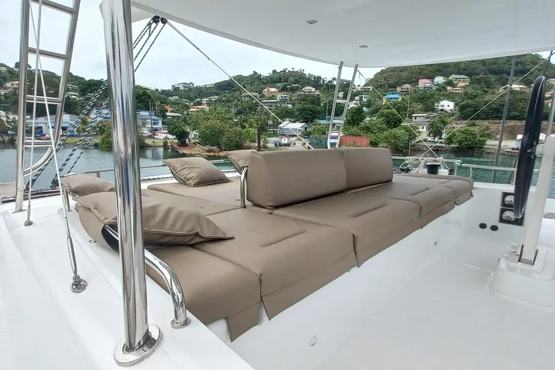 Amea Yacht Photos Pics Luxurious seating area on 2014 Lagoon 52 F yacht, docked with scenic waterfront view.