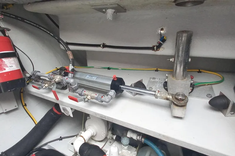Amea Yacht Photos Pics Engine compartment of 2014 Lagoon 52 F catamaran with fire extinguisher and plumbing components.
