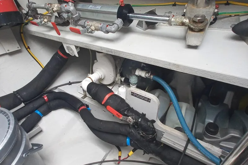 Amea Yacht Photos Pics Engine room of 2014 Lagoon 52 F yacht with visible plumbing and hoses.