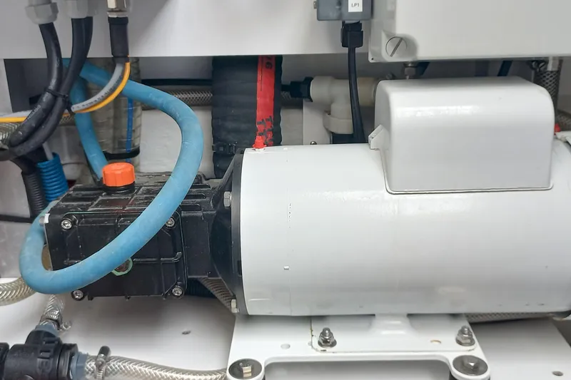 Amea Yacht Photos Pics Engine compartment of a 2014 Lagoon 52 F yacht, featuring various hoses and components.