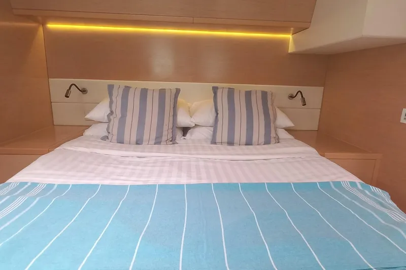 Amea Yacht Photos Pics Luxurious cabin interior of 2014 Lagoon 52 F yacht with striped bedding and ambient lighting.