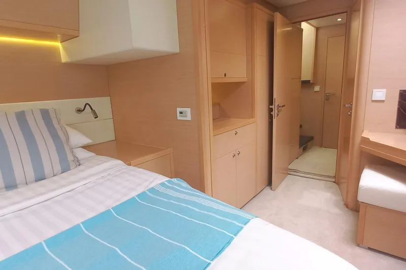 Amea Yacht Photos Pics Luxurious cabin interior of 2014 Lagoon 52 F yacht with cozy bedding and wooden furnishings.