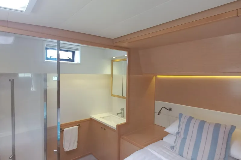 Amea Yacht Photos Pics Luxurious interior of 2014 Lagoon 52 F yacht with modern bathroom and cozy bedroom.