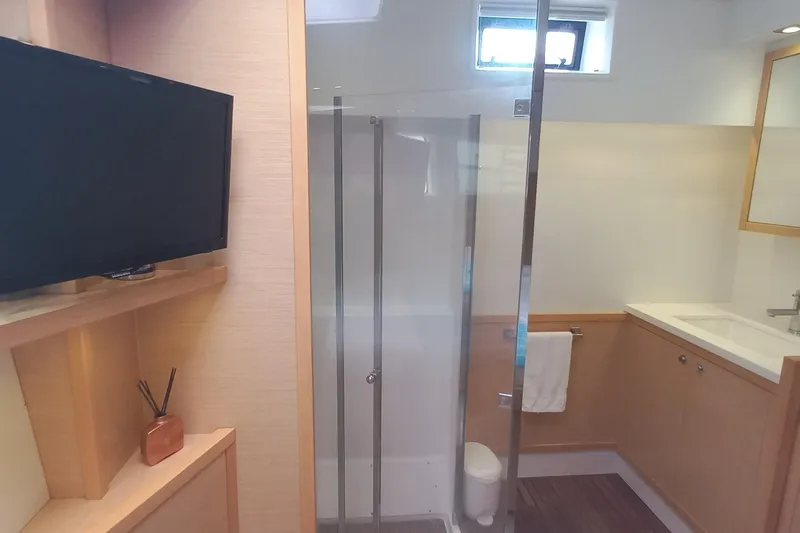 Amea Yacht Photos Pics Luxurious bathroom on 2014 Lagoon 52 F yacht with shower, TV, and modern amenities.