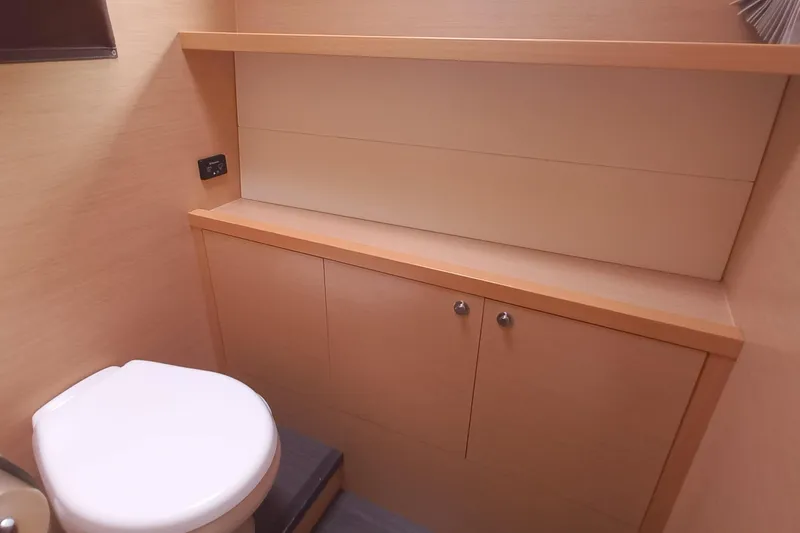 Amea Yacht Photos Pics 2014 Lagoon 52 F yacht bathroom with modern wooden cabinetry and toilet.