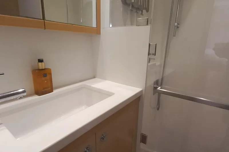 Amea Yacht Photos Pics Luxurious bathroom interior of 2014 Lagoon 52 F yacht with modern sink and shower.