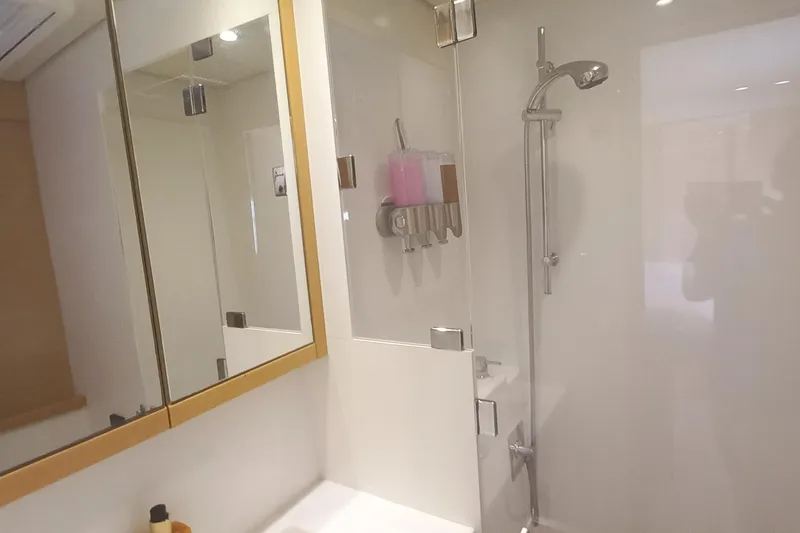 Amea Yacht Photos Pics Modern bathroom interior on 2014 Lagoon 52 F yacht, featuring shower and mirrored cabinet.