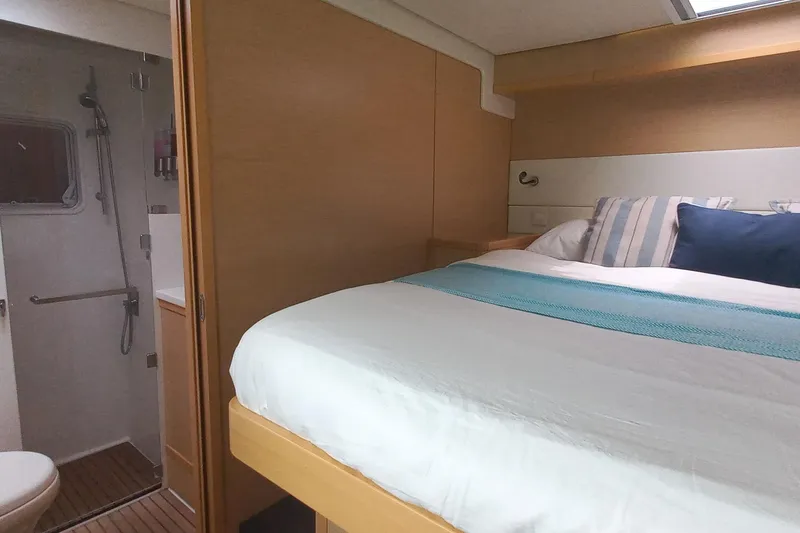Amea Yacht Photos Pics Interior of 2014 Lagoon 52 F yacht cabin with bed and ensuite bathroom.
