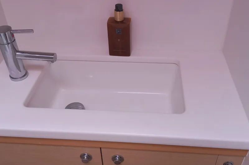 Amea Yacht Photos Pics White sink with chrome faucet and soap bottle on Lagoon 52 F, 2014 model.