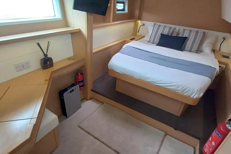 Amea Yacht Photos Pics Luxurious cabin interior of 2014 Lagoon 52 F yacht with cozy bed and modern amenities.