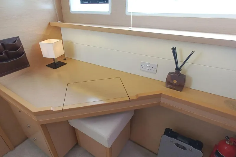 Amea Yacht Photos Pics Interior of 2014 Lagoon 52 F yacht with desk, lamp, and reed diffuser.