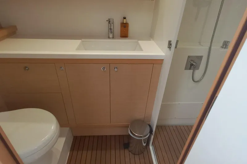 Amea Yacht Photos Pics Bathroom interior of 2014 Lagoon 52 F yacht with modern fixtures and wooden cabinetry.