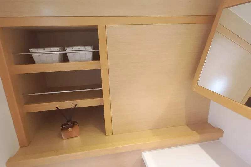 Amea Yacht Photos Pics Interior of 2014 Lagoon 52 F yacht with wooden shelves and a mirror.