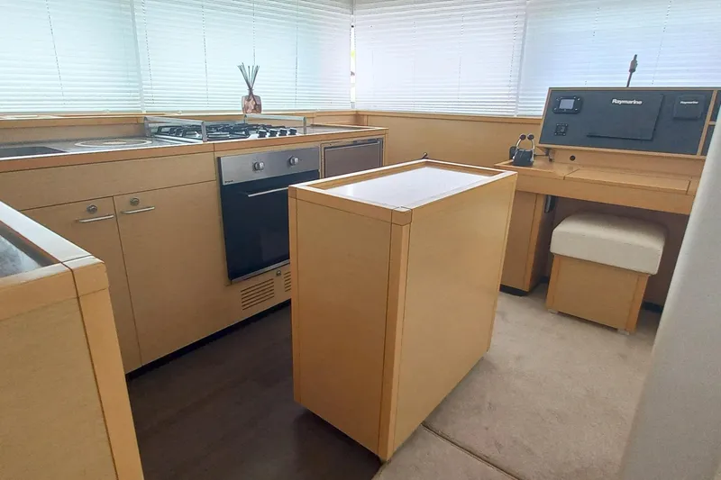 Amea Yacht Photos Pics Modern kitchen interior of 2014 Lagoon 52 F yacht with stove and navigation equipment.