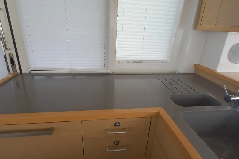 Amea Yacht Photos Pics Modern kitchen interior of 2014 Lagoon 52 F yacht with sleek countertops and sink.