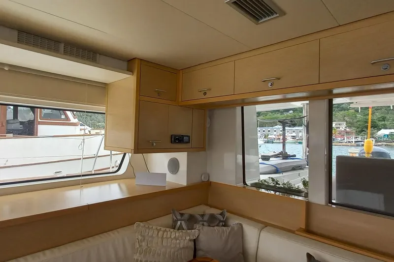 Amea Yacht Photos Pics Interior of 2014 Lagoon 52 F yacht with wooden cabinets and large windows.