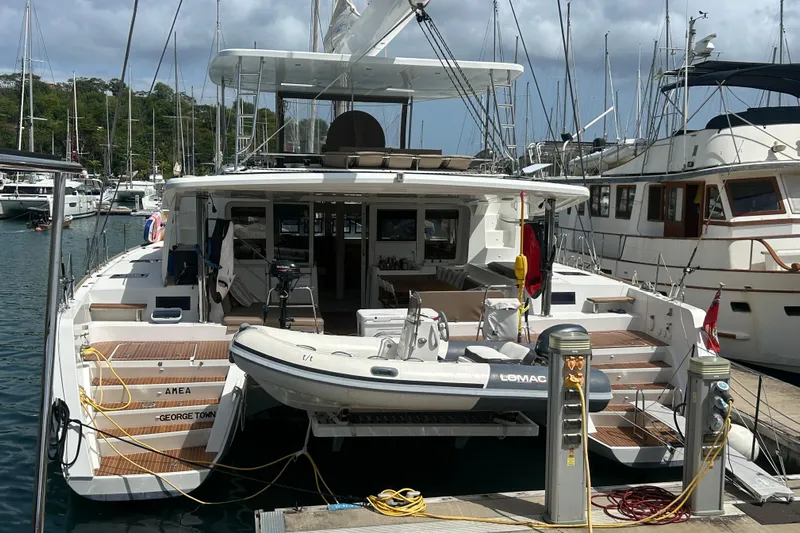 Amea Yacht Photos Pics 2014 Lagoon 52 F catamaran docked in marina.