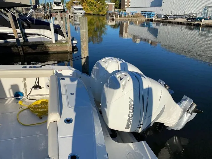  Yacht Photos Pics 2019 Boston Whaler 330 Outrage with Mercury engines docked in a marina.