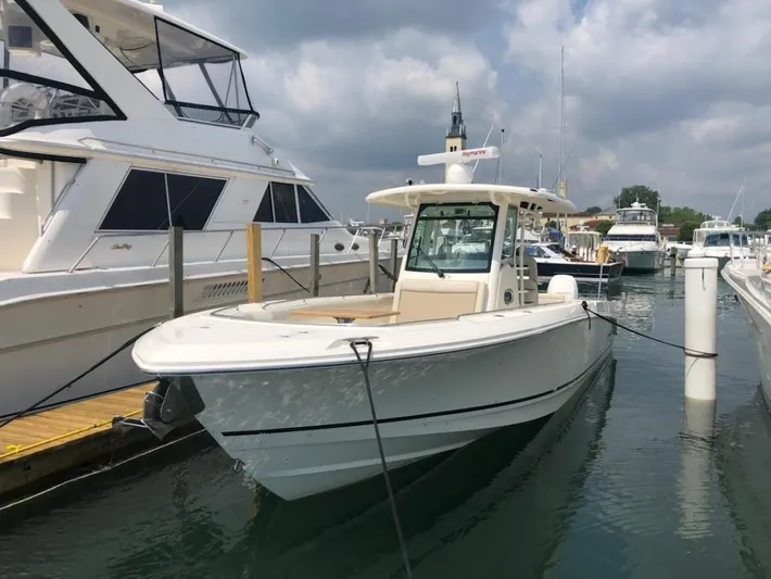  Yacht Photos Pics 2019 Boston Whaler 330 Outrage docked at marina under cloudy sky.