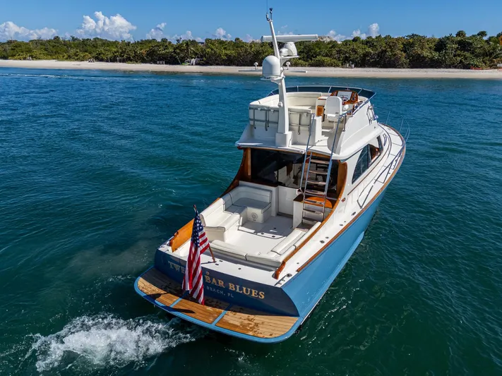 Twelve Bar Blues Yacht Photos Pics 2019 Hinckley Talaria 43 Flybridge yacht cruising near a tropical shoreline.