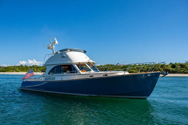 Twelve Bar Blues Yacht Photos Pics 2019 Hinckley Talaria 43 Flybridge yacht cruising on clear blue water.