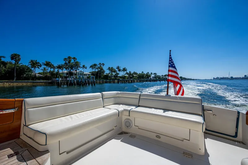 Twelve Bar Blues Yacht Photos Pics Hinckley Talaria 43 Flybridge 2019 yacht with American flag, cruising on a sunny day.