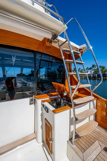 Twelve Bar Blues Yacht Photos Pics 2019 Hinckley Talaria 43 Flybridge yacht with wooden accents and stainless steel ladder.