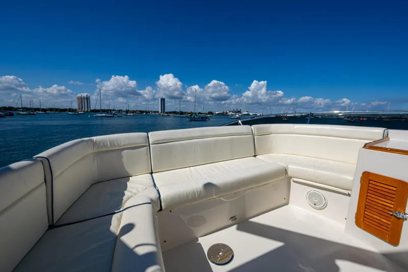 Twelve Bar Blues Yacht Photos Pics Hinckley Talaria 43 Flybridge 2019 yacht with white seating, overlooking a scenic waterfront.