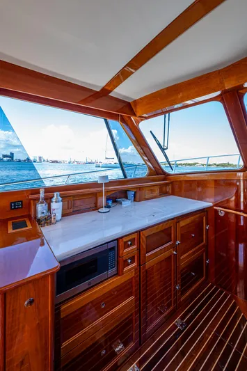 Twelve Bar Blues Yacht Photos Pics Luxurious interior of 2019 Hinckley Talaria 43 Flybridge yacht with wooden cabinetry and ocean view.