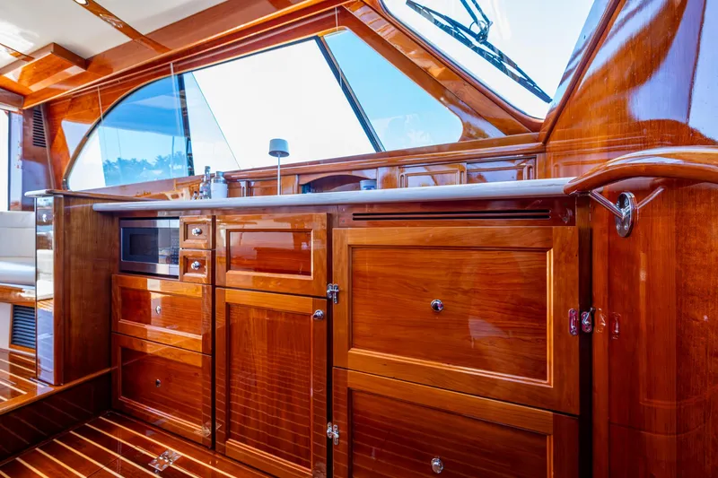 Twelve Bar Blues Yacht Photos Pics Luxurious wood interior of 2019 Hinckley Talaria 43 Flybridge yacht kitchen area.