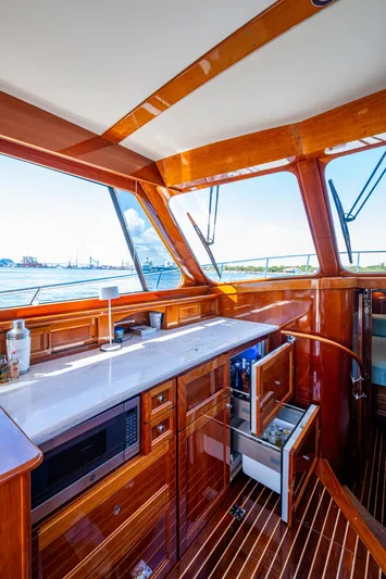 Twelve Bar Blues Yacht Photos Pics Luxurious 2019 Hinckley Talaria 43 Flybridge interior with elegant wood finish and modern amenities.