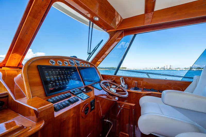 Twelve Bar Blues Yacht Photos Pics 2019 Hinckley Talaria 43 Flybridge helm with polished wood and modern navigation equipment.