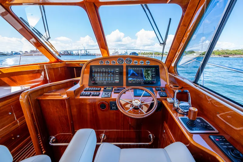 Twelve Bar Blues Yacht Photos Pics Luxurious 2019 Hinckley Talaria 43 Flybridge helm with polished wood and advanced navigation systems.