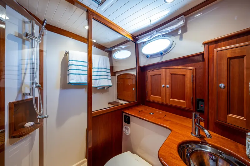 Twelve Bar Blues Yacht Photos Pics Luxurious 2019 Hinckley Talaria 43 Flybridge bathroom with wood cabinetry and modern fixtures.