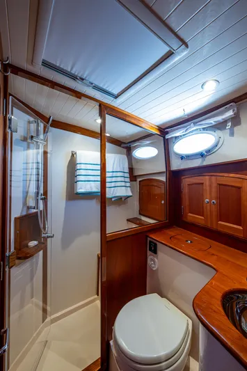 Twelve Bar Blues Yacht Photos Pics Luxurious 2019 Hinckley Talaria 43 Flybridge bathroom with wood accents and modern fixtures.