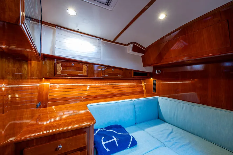 Twelve Bar Blues Yacht Photos Pics Luxurious 2019 Hinckley Talaria 43 Flybridge cabin with polished wood and cozy seating.