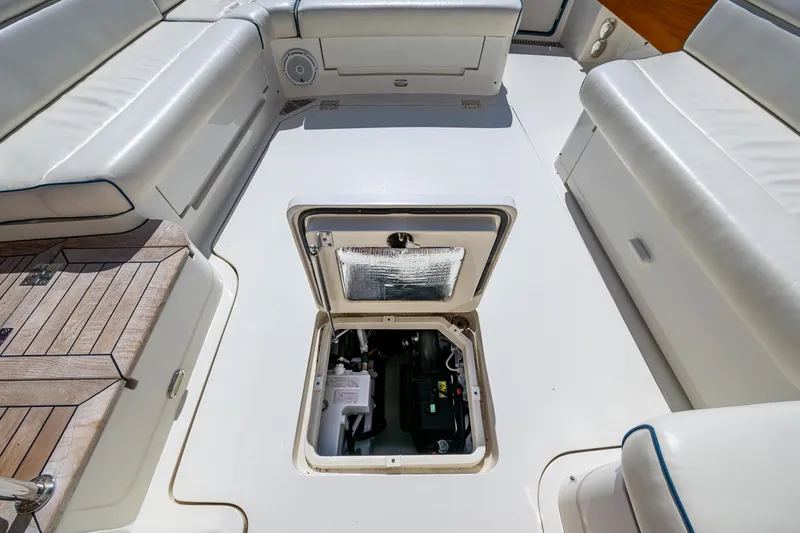 Twelve Bar Blues Yacht Photos Pics 2019 Hinckley Talaria 43 Flybridge engine compartment, surrounded by white seating and teak flooring.