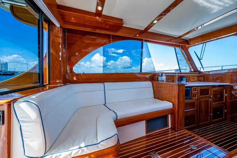 Twelve Bar Blues Yacht Photos Pics Luxurious interior of 2019 Hinckley Talaria 43 Flybridge with elegant wood finish and white seating.