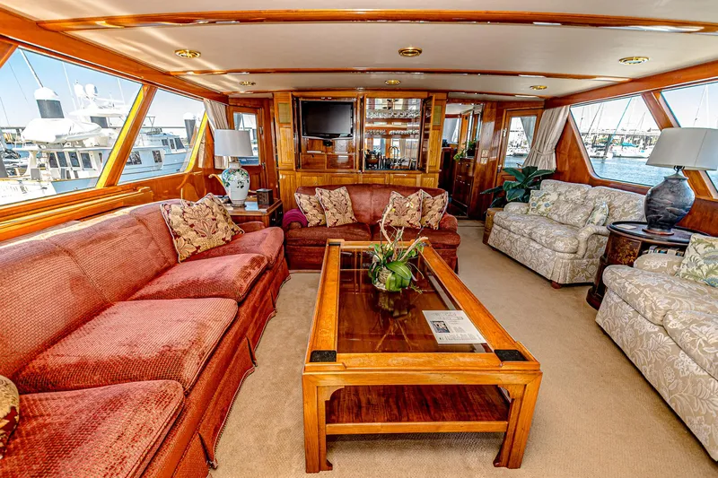 Diday Yacht Photos Pics Luxurious yacht interior with plush seating, wooden accents, and large windows, 1984 Burger 91 model.
