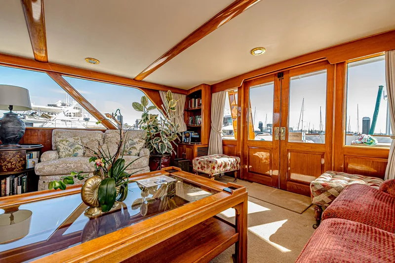 Diday Yacht Photos Pics Luxurious interior of a 1984 Burger 91 yacht with elegant wood finishes and marina view.