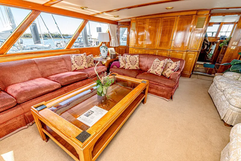 Diday Yacht Photos Pics Luxurious yacht interior with plush seating, wooden accents, and large windows, 1984 Burger model 91.