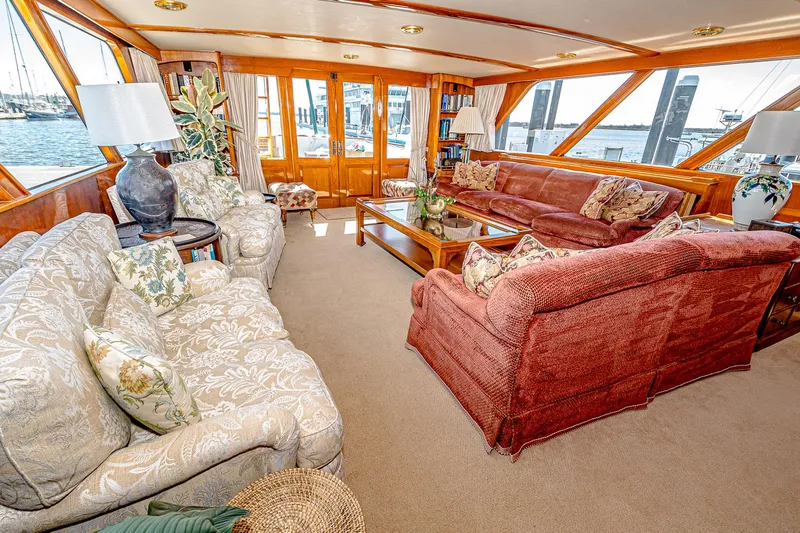 Diday Yacht Photos Pics Luxurious yacht interior with plush sofas, wooden accents, and waterfront views, 1984 Burger model 91.