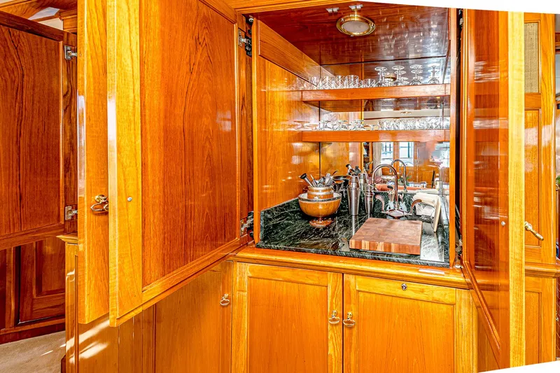 Diday Yacht Photos Pics Luxurious wooden yacht interior with bar area, glassware, and elegant cabinetry, Burger 91, 1984 model.