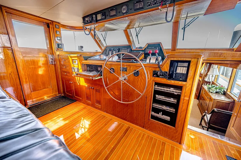 Diday Yacht Photos Pics Luxurious 1984 Burger 91 yacht helm with polished wood and modern navigation instruments.