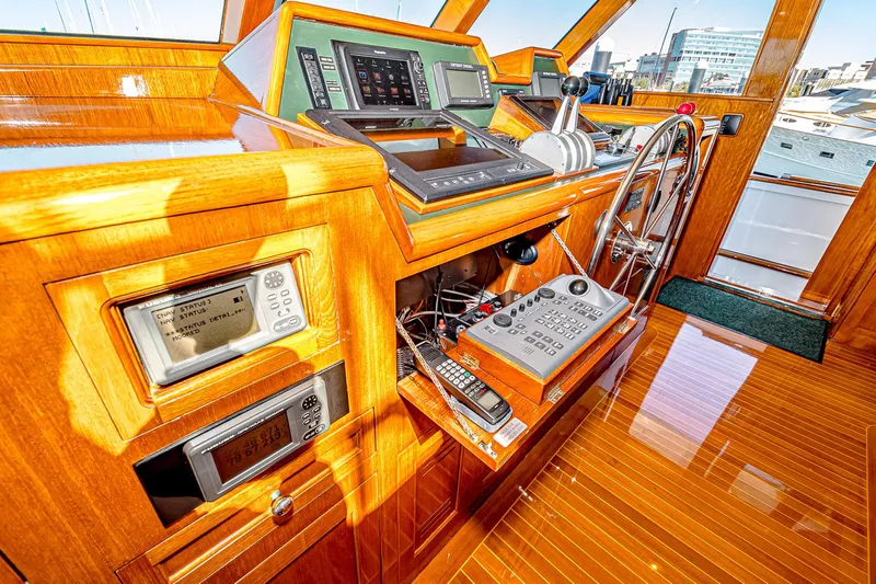 Diday Yacht Photos Pics Luxurious 1984 Burger 91 yacht helm with polished wood and advanced navigation equipment.