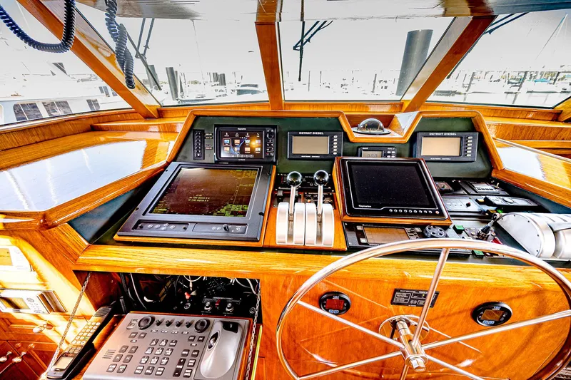 Diday Yacht Photos Pics Control panel of a 1984 Burger 91 yacht with navigation equipment and steering wheel.